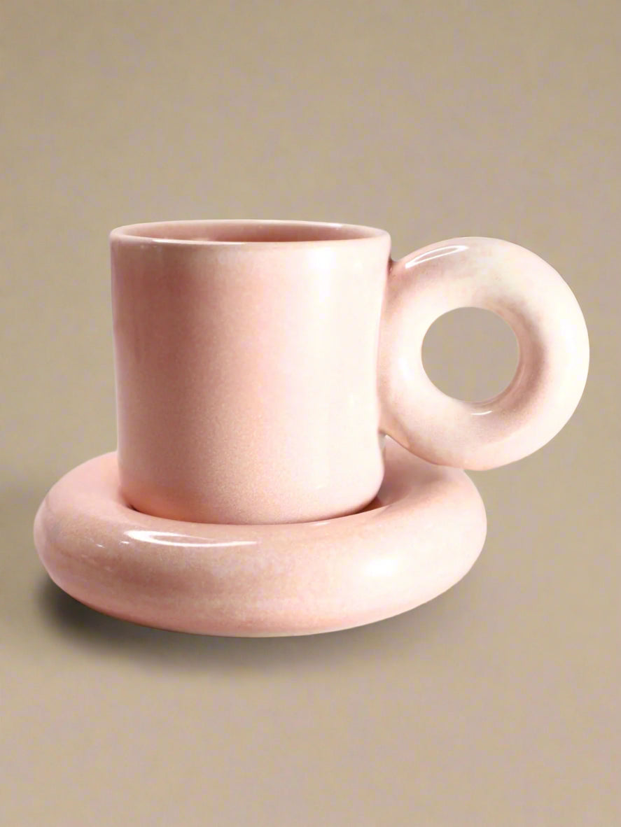 a cup and saucer sitting on a table
