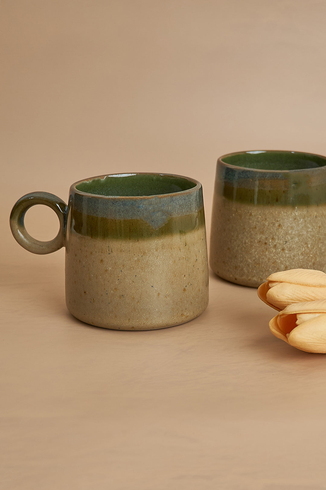 a couple of coffee mugs sitting on top of a table