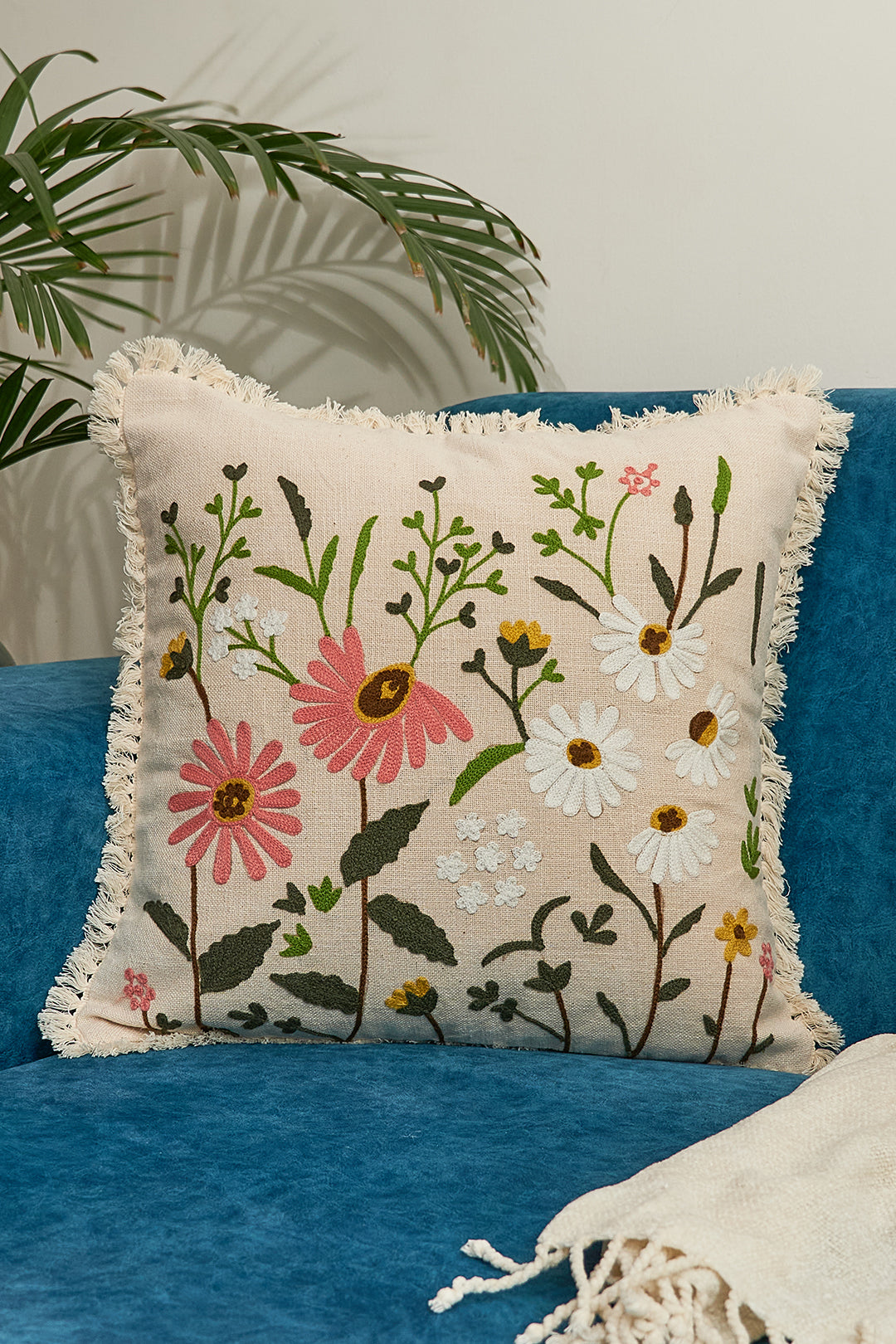 a blue couch with a white throw pillow on top of it