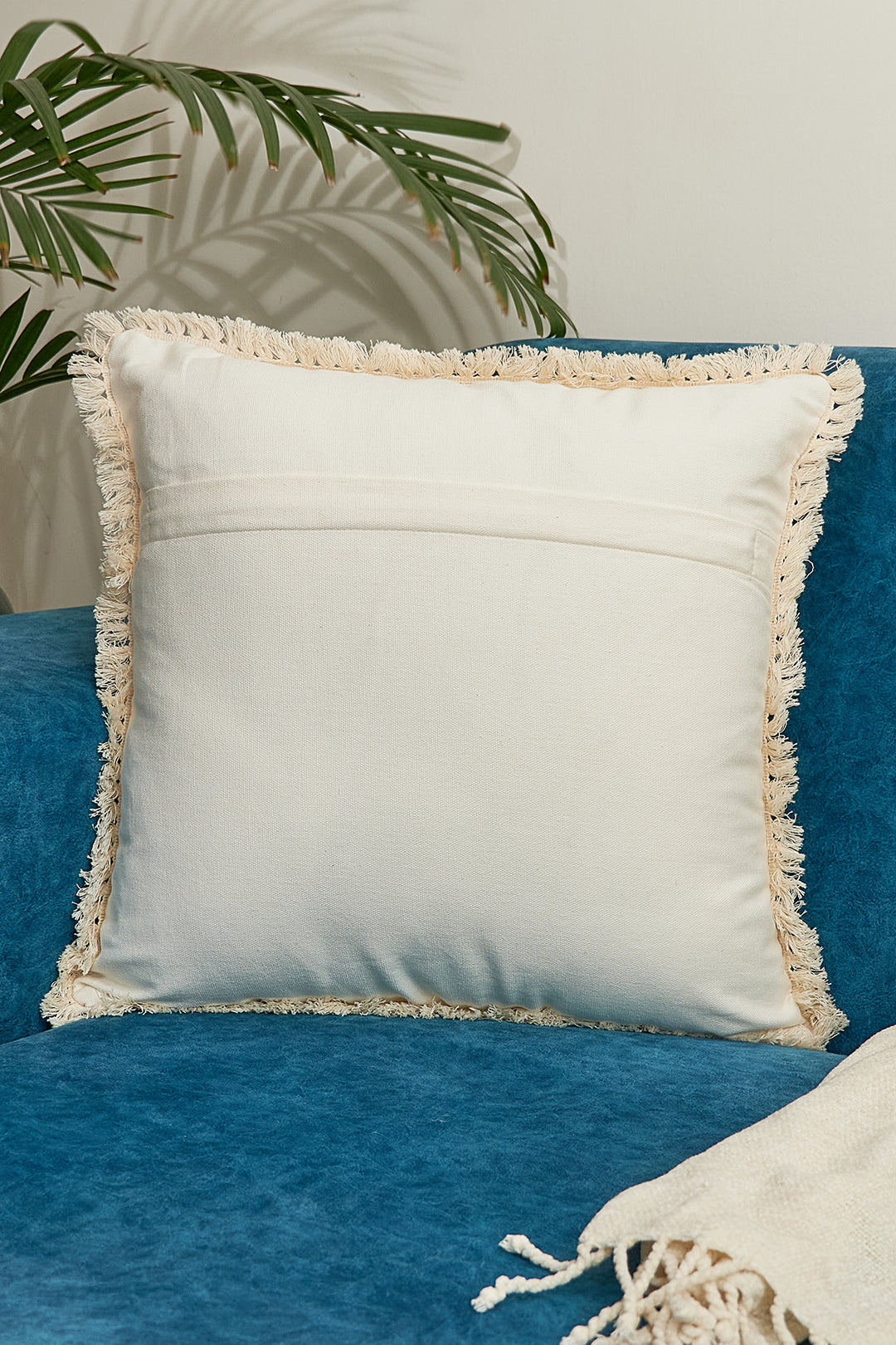 a blue chair with a white pillow on it