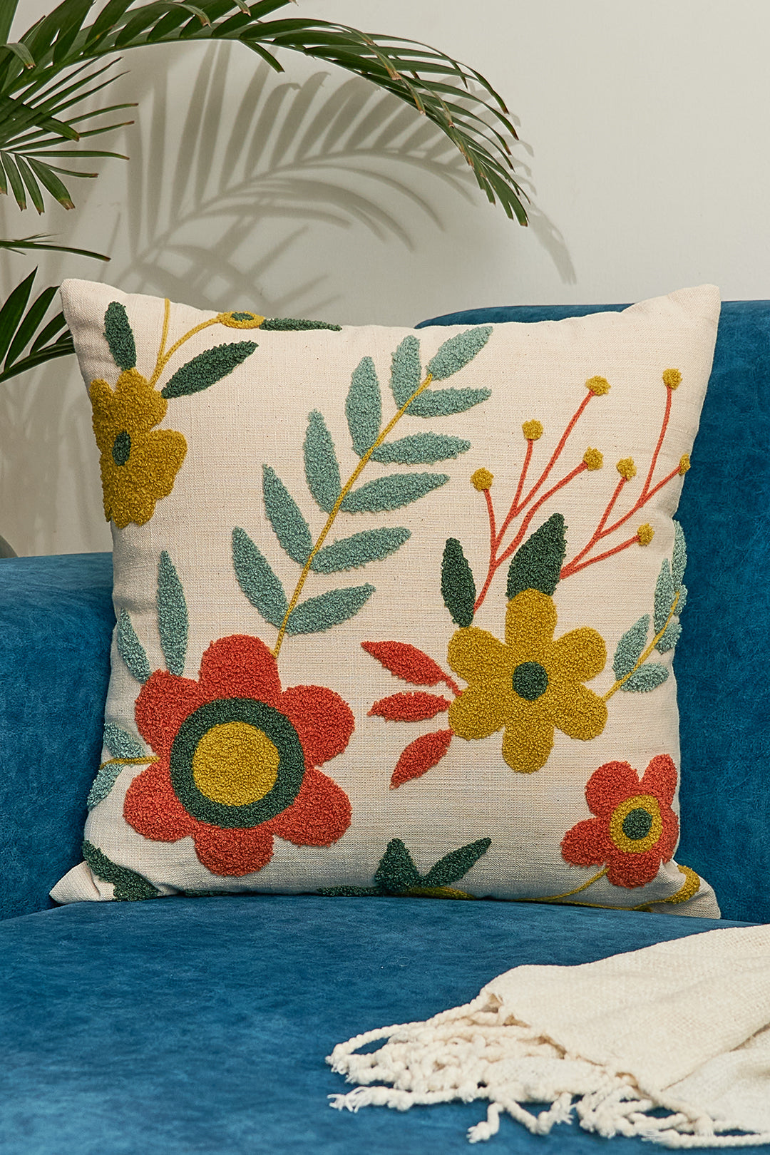 a blue couch with a floral pillow on top of it