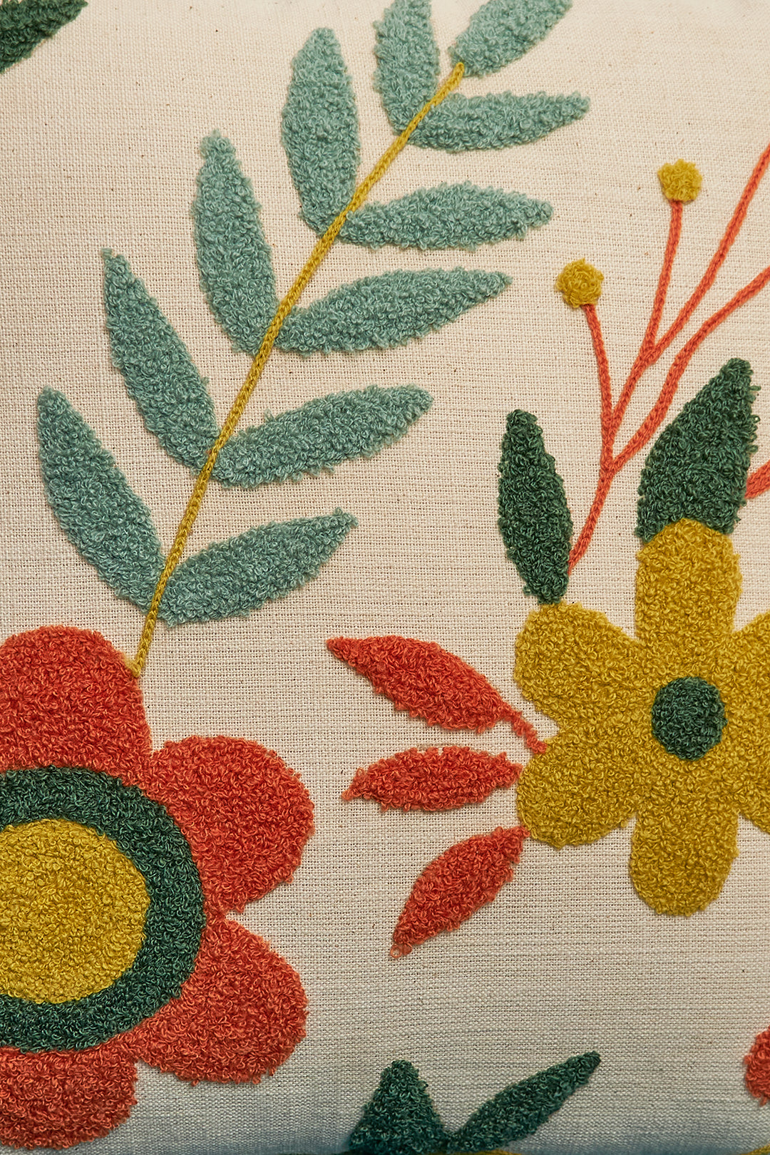 a close up of a pillow with flowers on it
