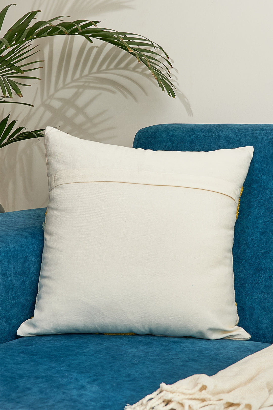 a blue chair with a white pillow on it