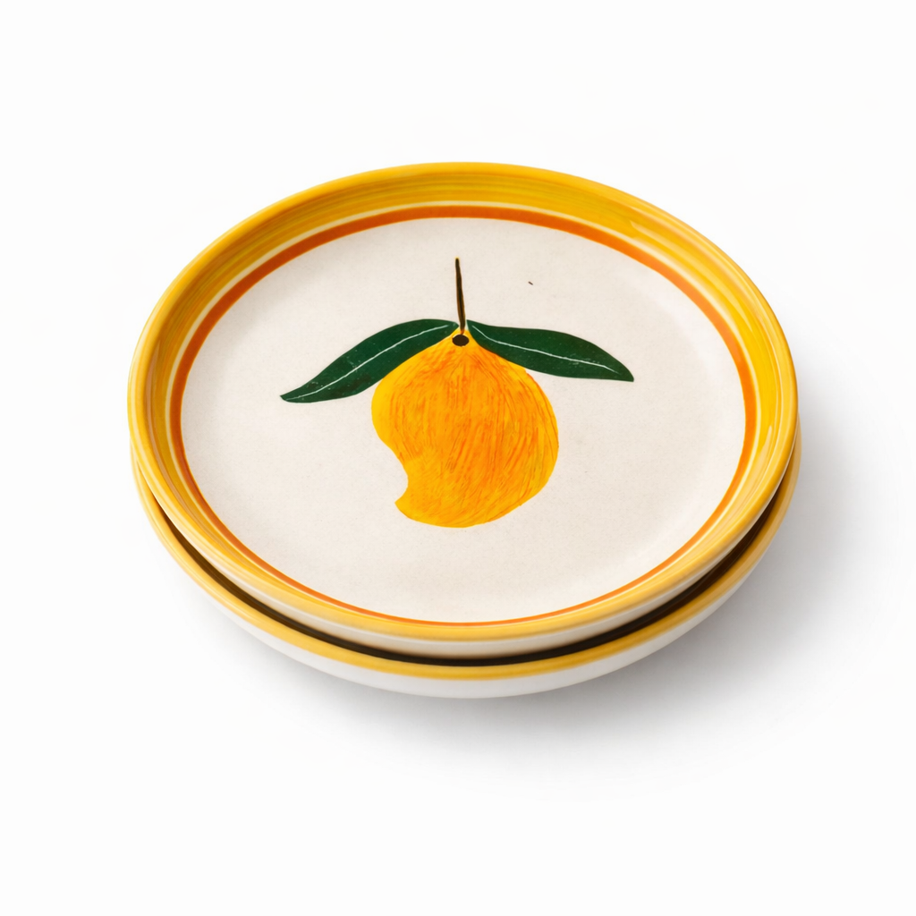 Stack of ceramic plates with lemon design on a white background