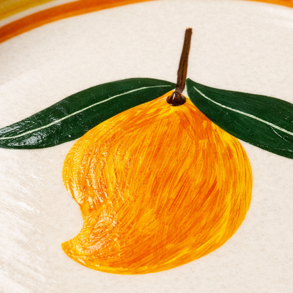 Hand-painted illustration of a yellow fruit with green leaves on a white background
