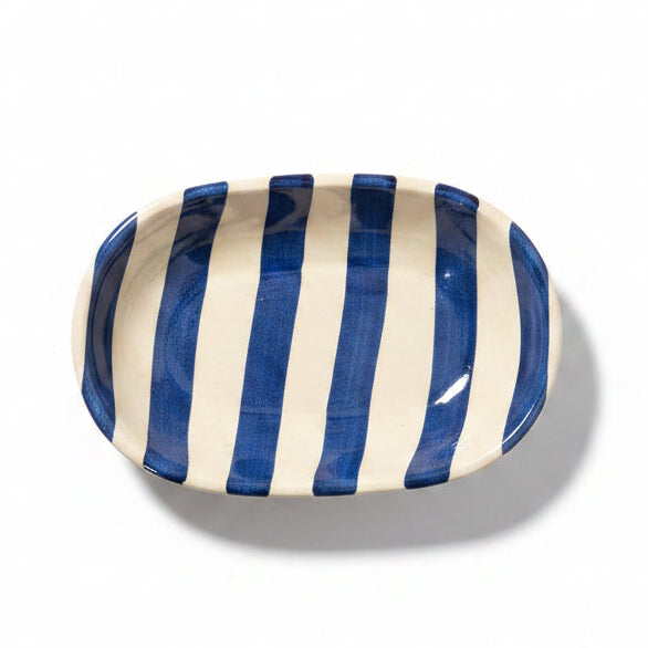 Ceramic dish with blue and white stripes on a white background