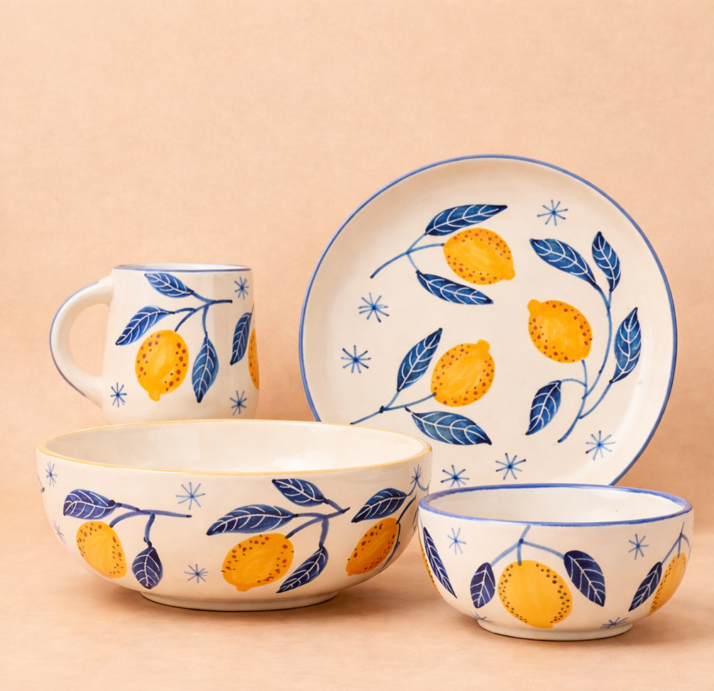 Ceramic tableware set with lemon and leaf pattern on a beige background