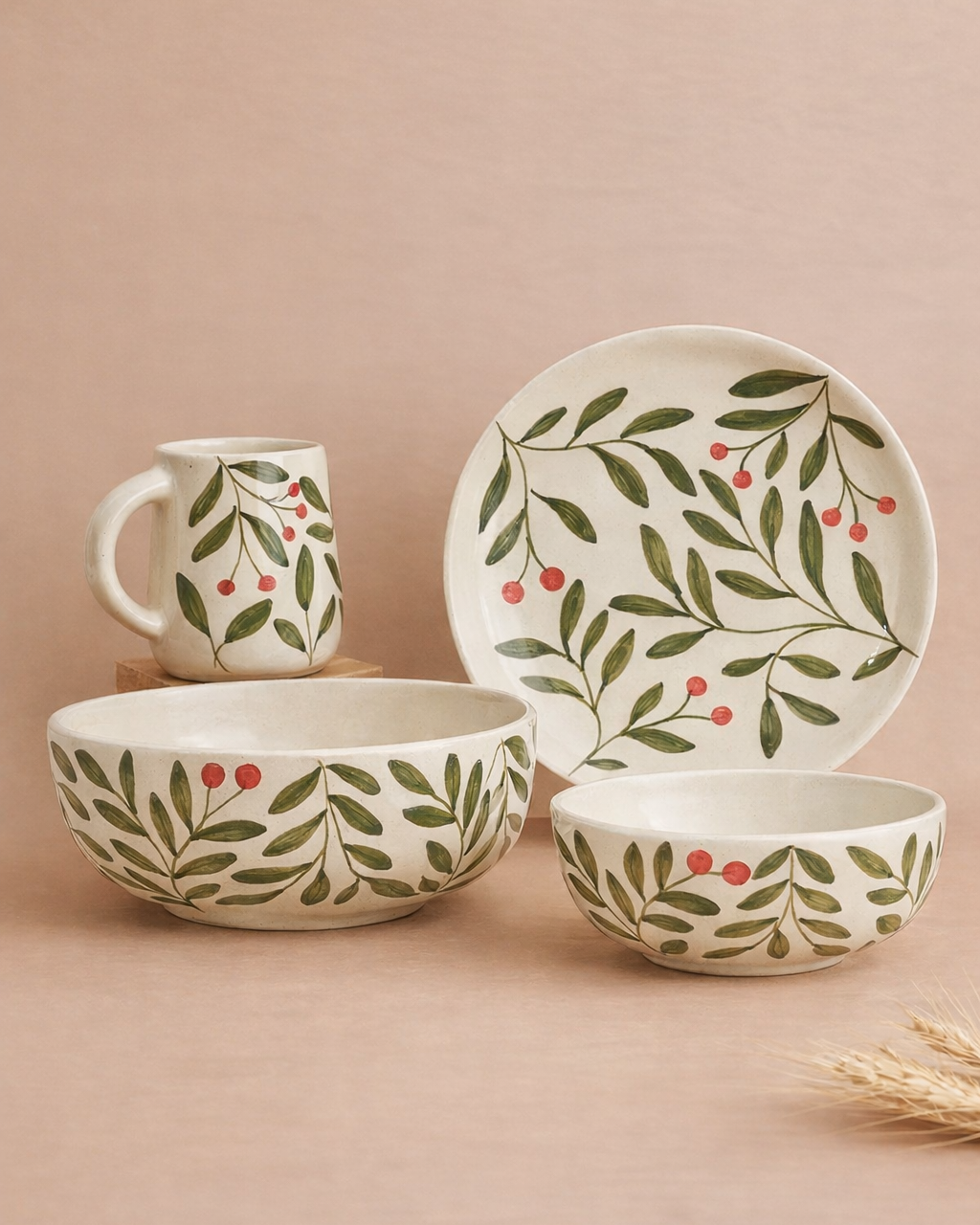 Ceramic tableware set with leaf and berry pattern on a beige background