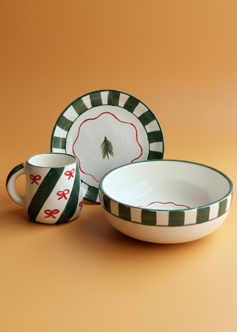 Ceramic dish set with green and red patterns on a beige background
