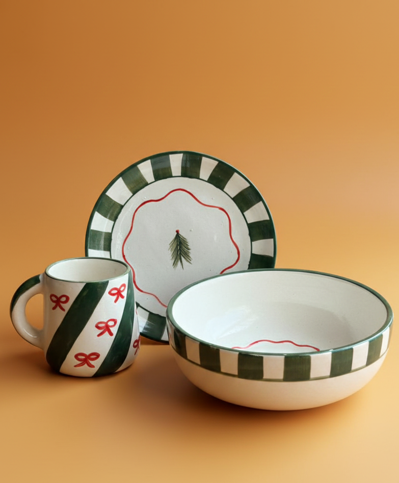 Ceramic dish set with green and red patterns on a beige background
