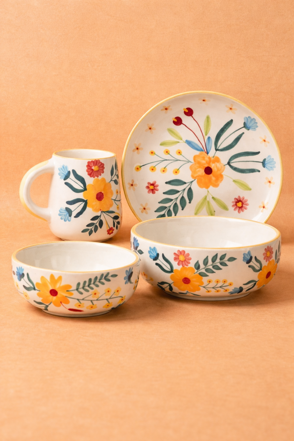 Ceramic tableware set with floral designs on a peach background