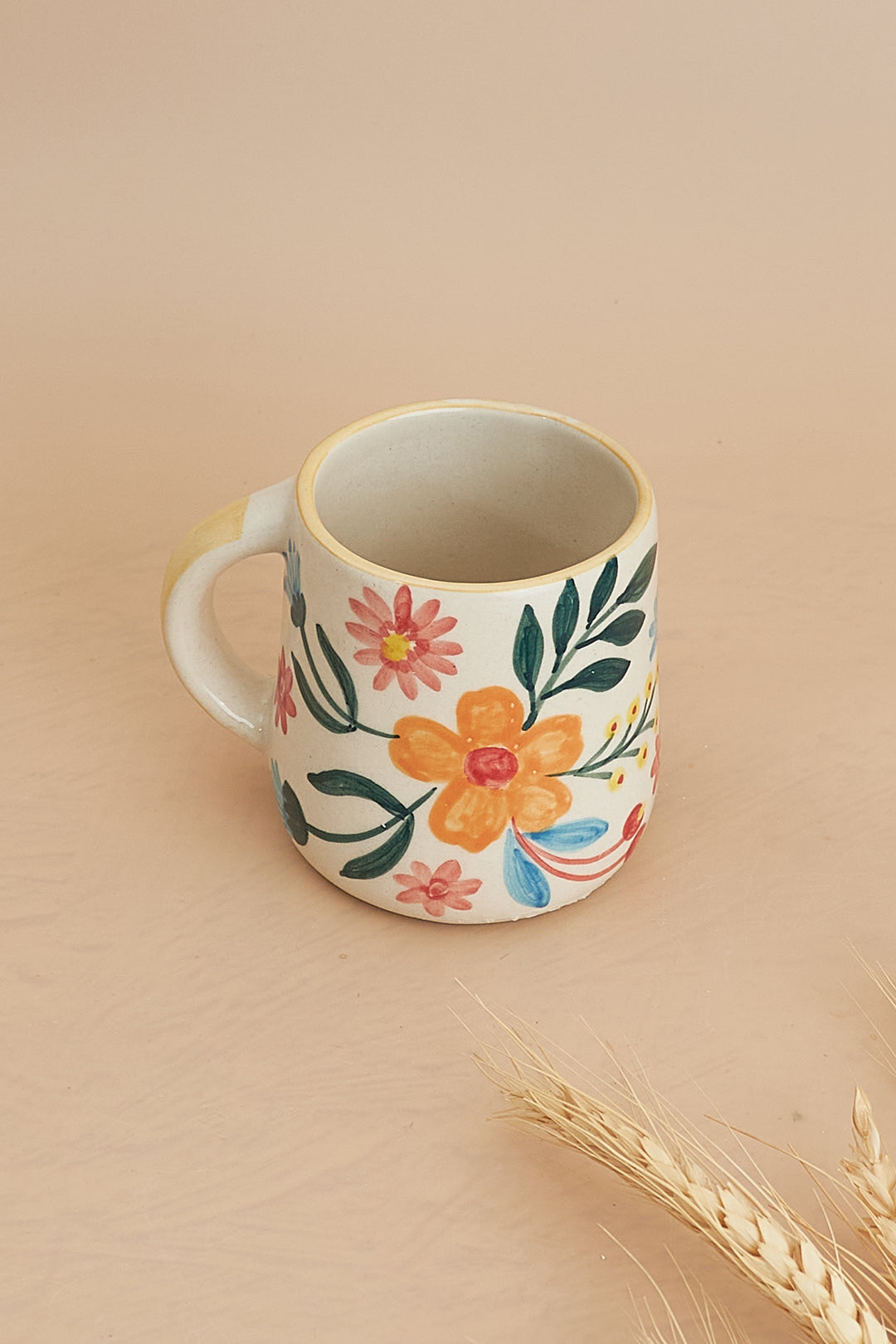 a coffee cup with a flower painted on it