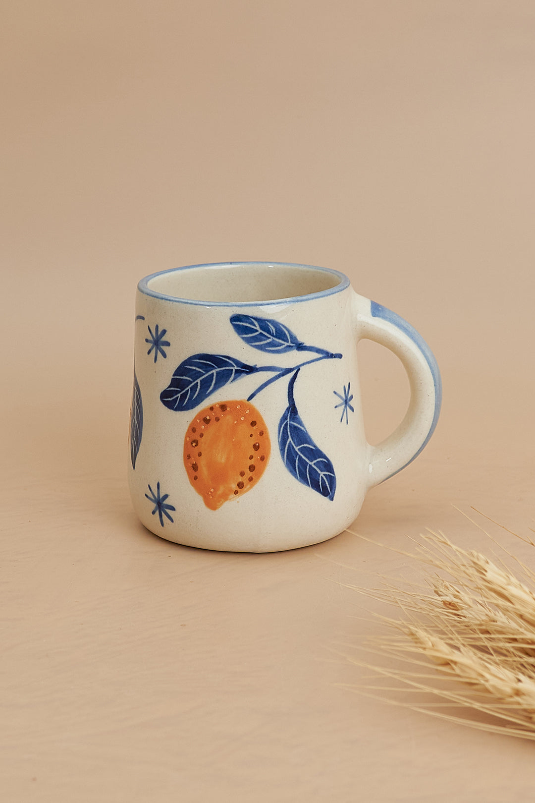 A set of breakfastware with a floral pattern, predominantly featuring yellow and green colors, on a beige background.