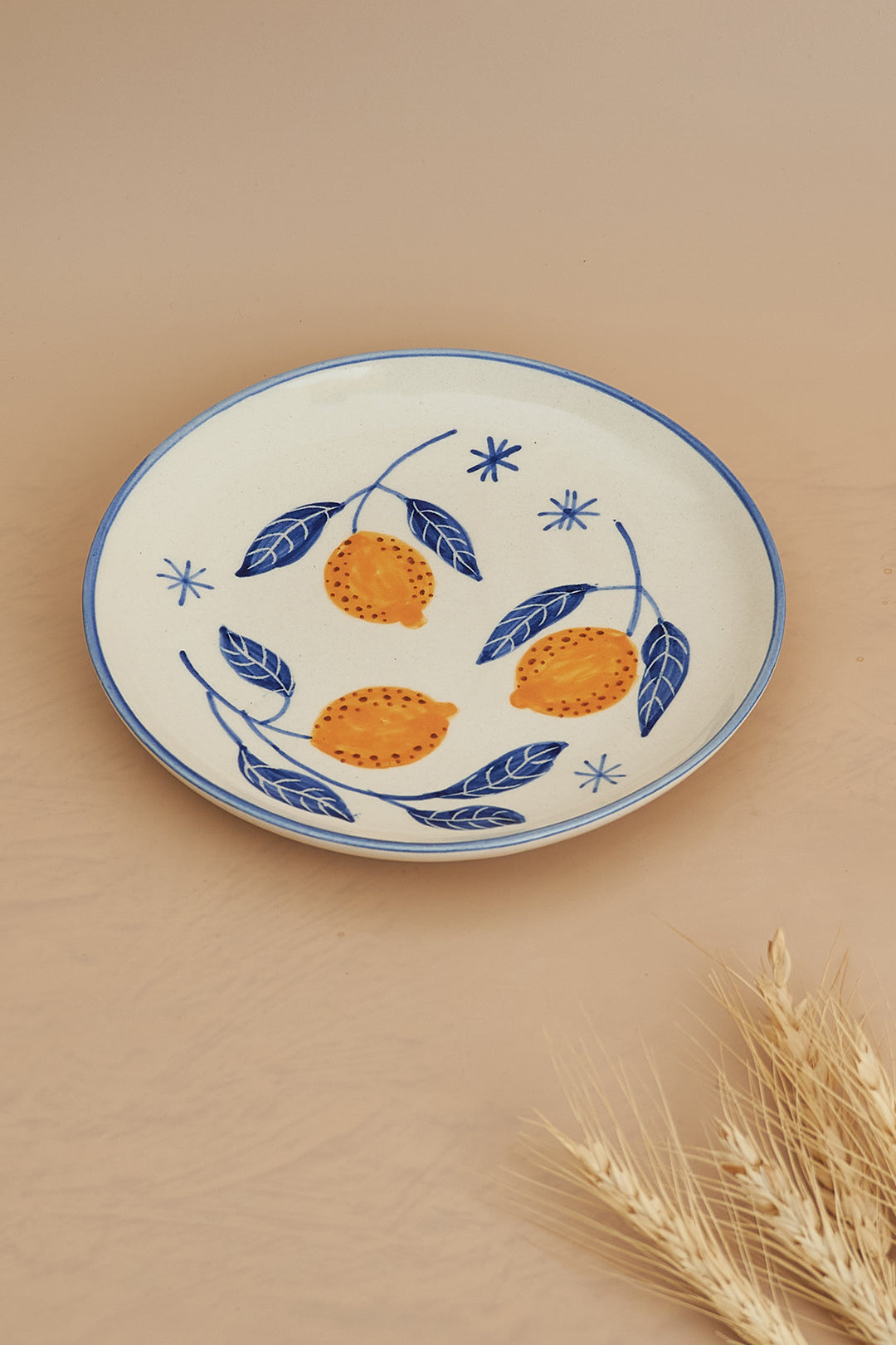 A set of breakfastware with a floral pattern, predominantly featuring yellow and green colors, on a beige background.