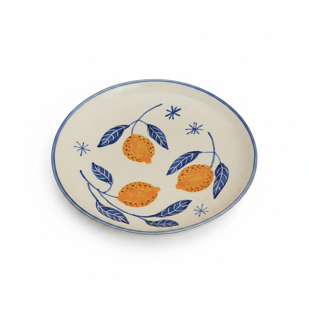 A set of breakfastware with a floral pattern, predominantly featuring yellow and green colors, on a beige background.