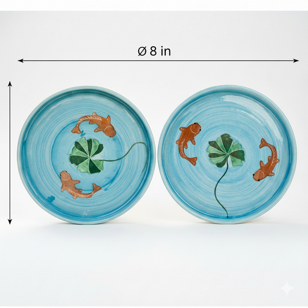 Two ceramic plates with fish and clover design on a white background