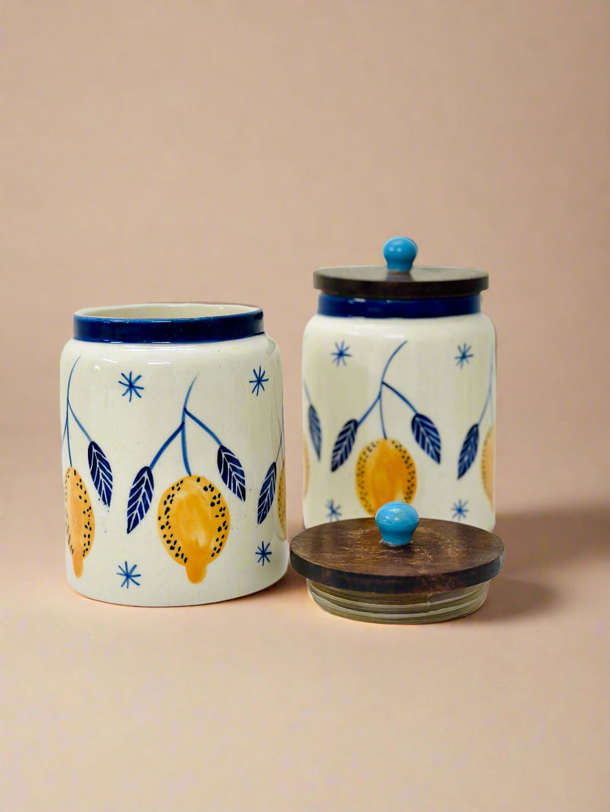 Two ceramic jars with lemon designs on a beige background