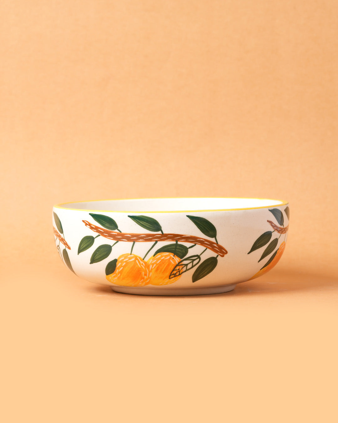 Ceramic bowl with orange design on a beige background
