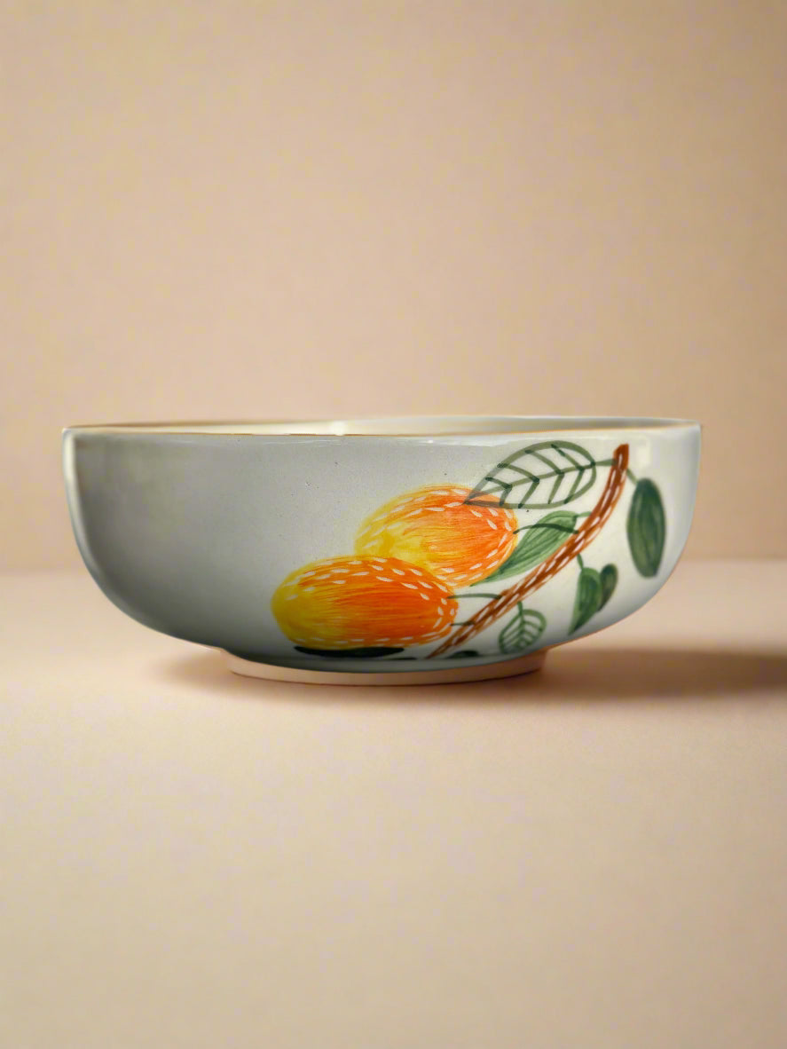 Ceramic bowl with fruit design on a beige background