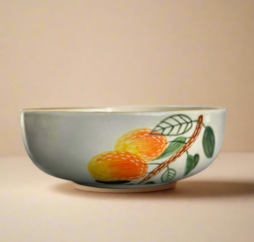 Ceramic bowl with fruit design on a beige background
