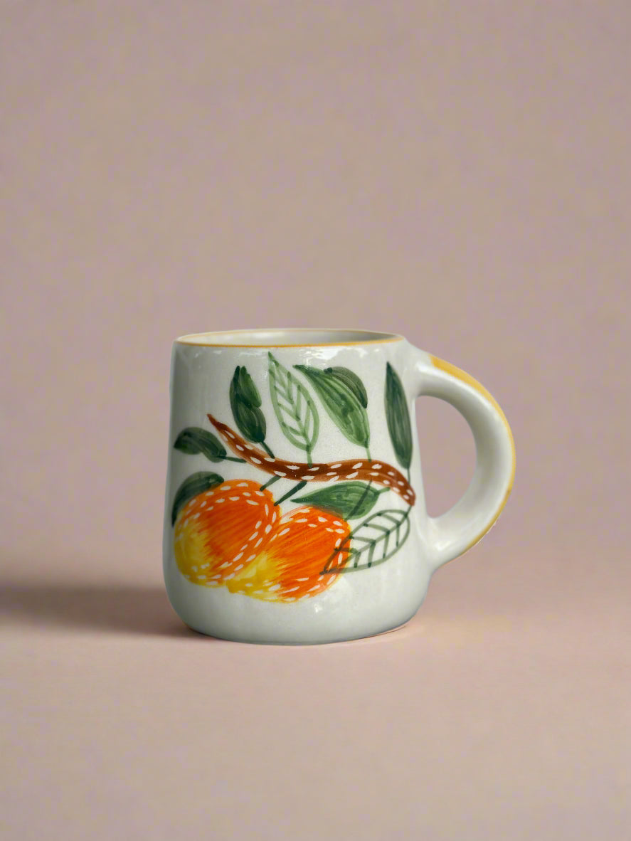 Mug with fruit design on a reflective surface