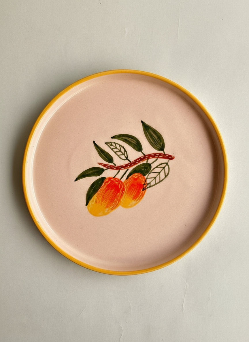 Decorative plate with a yellow rim and fruit design on a light gray background