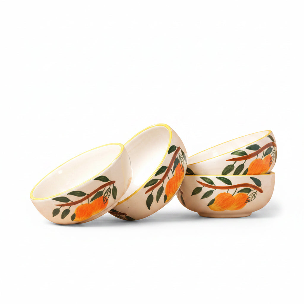 Set of ceramic bowls with orange and leaf design on a beige background