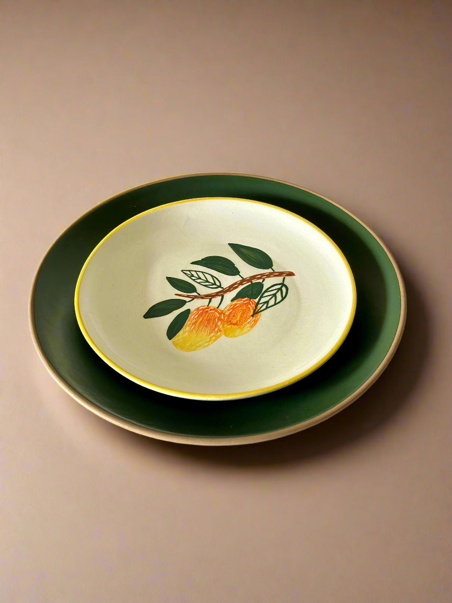 Decorative plate with a leaf and fruit design on a beige background