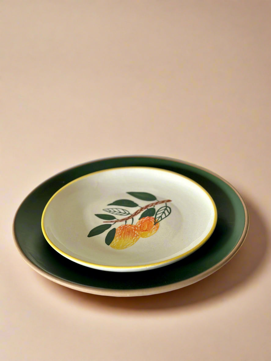 Set of ceramic plates with fruit design on a beige background