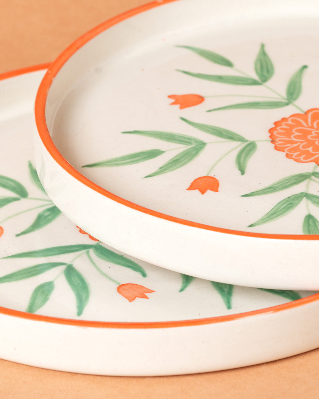 Decorative ceramic plates with floral patterns on a wooden surface
