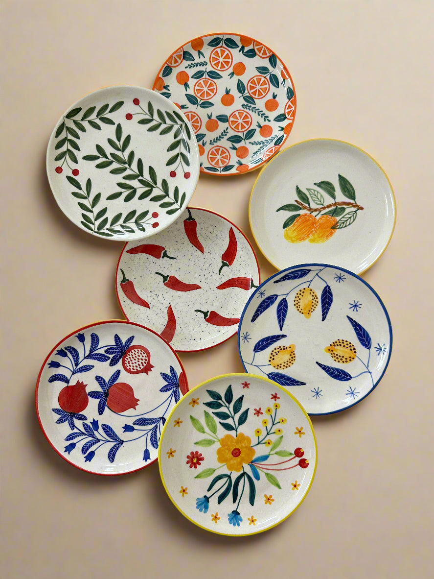 Set of colorful ceramic plates with various patterns on a white background