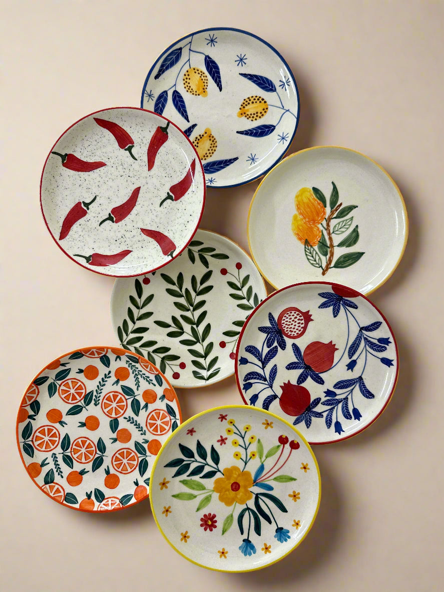 Set of colorful ceramic plates with various patterns on a white background