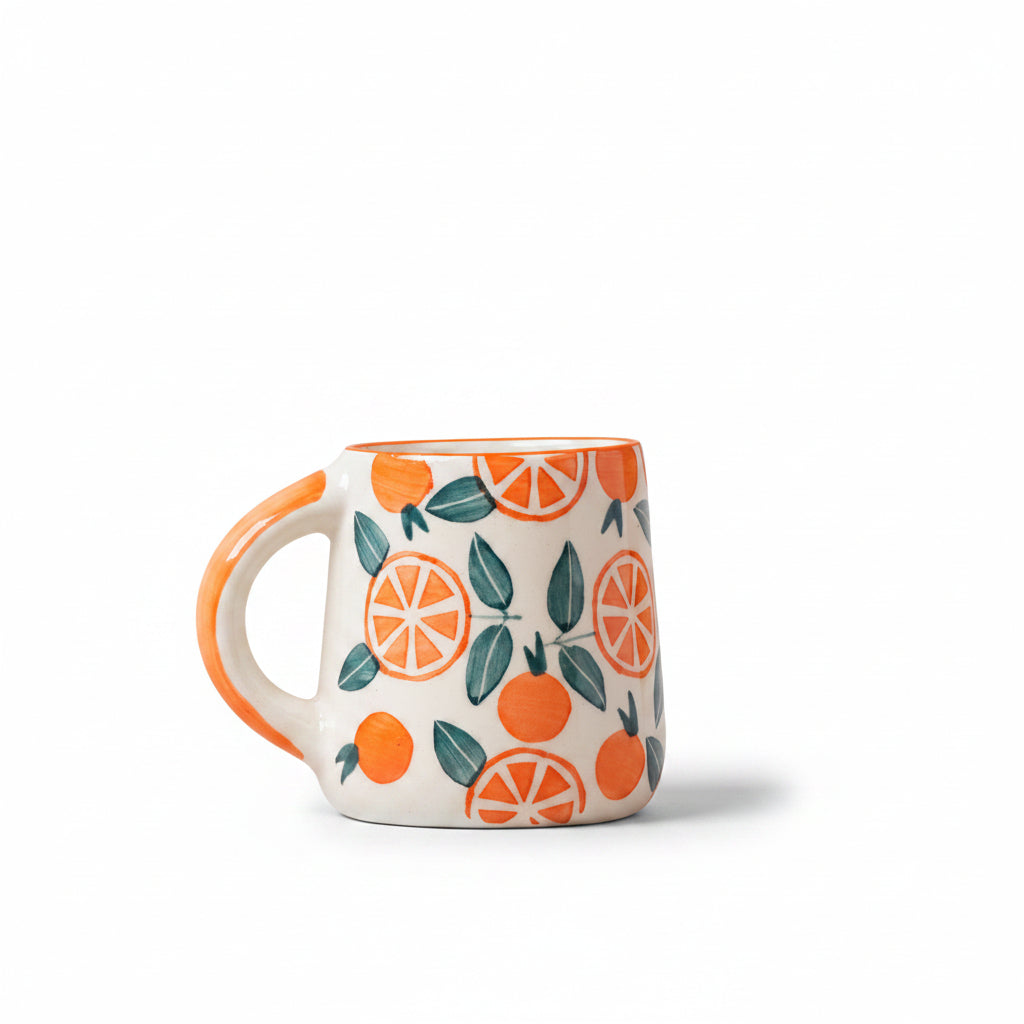 Narangi Orange ceramic coffee mug decorated with a bright orange fruit and leaf design.