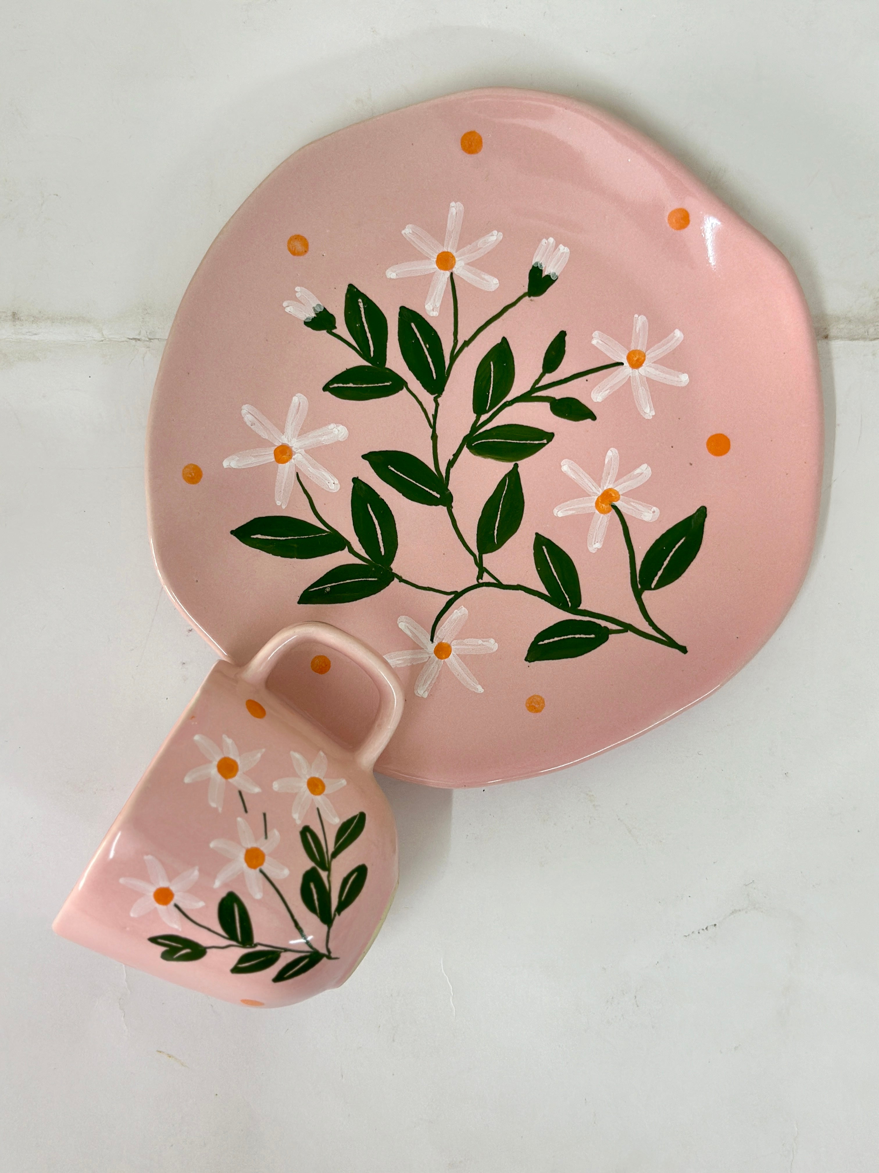 Pink ceramic plate with floral design on a white background