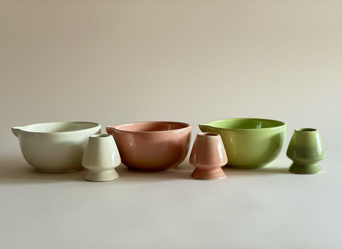 Set of ceramic bowls in various colors on a plain background