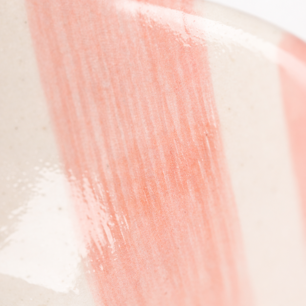 Close-up of pink lip balm on a beige background