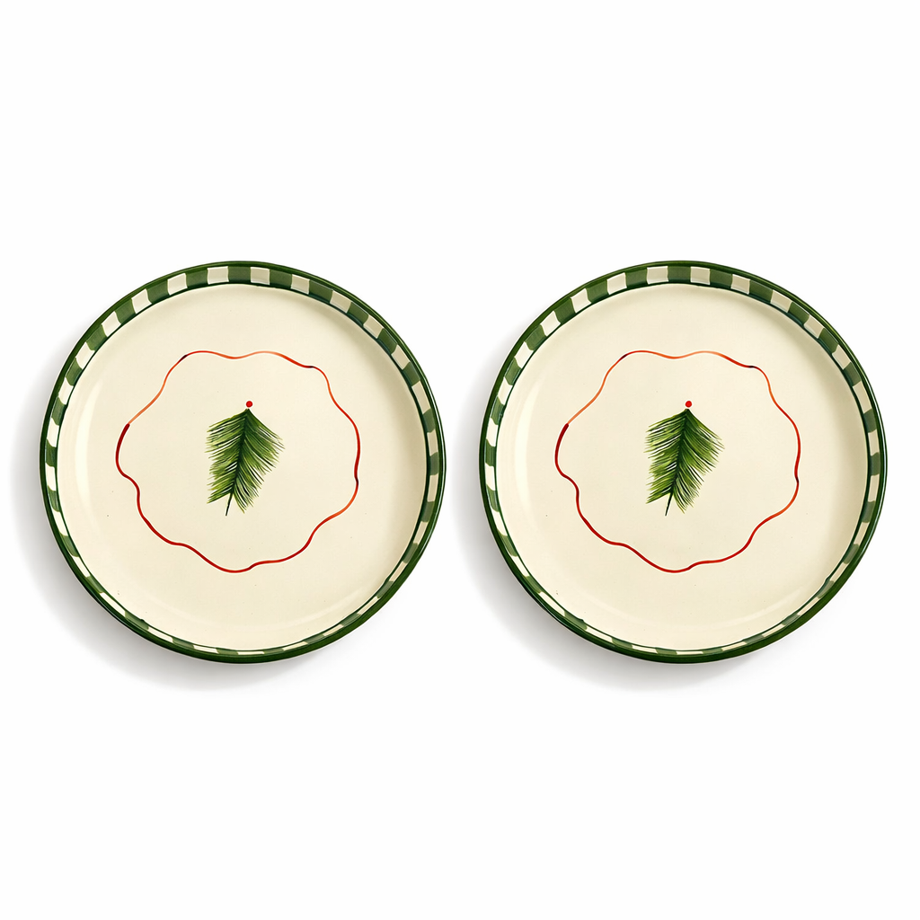 Two ceramic plates with green leaf design on a white background
