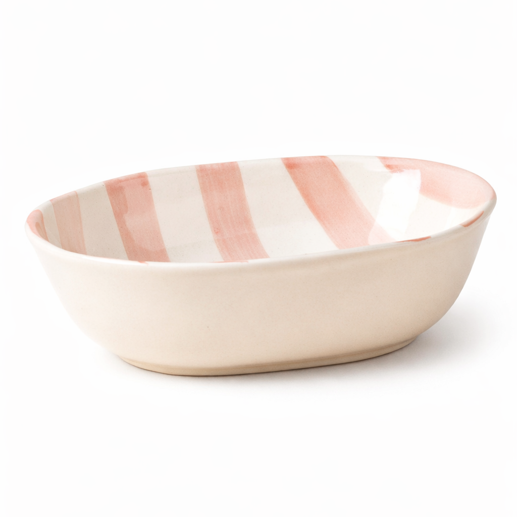 Ceramic bowl with pink and white stripes on a white background