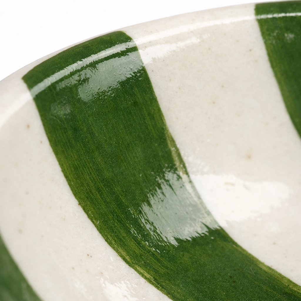 Close-up of a ceramic dish with green and white stripes
