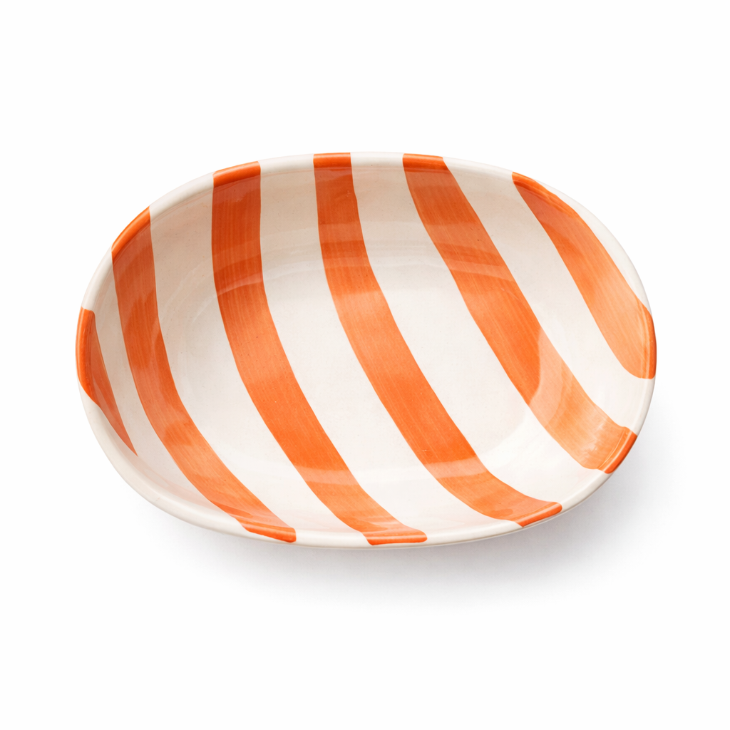 Striped ceramic plate with orange and white stripes on a white background