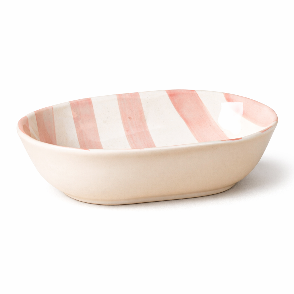 Striped ceramic bowl with pink and white stripes on a white background