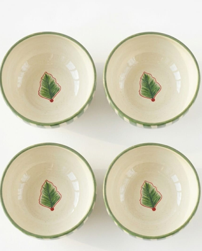 Four ceramic bowls with leaf designs on a white background