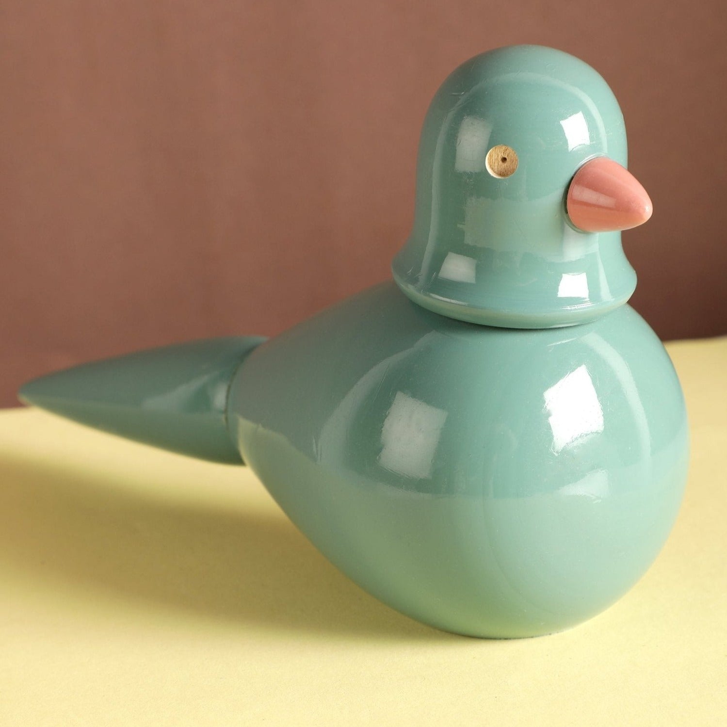 a small blue bird sitting on top of a table