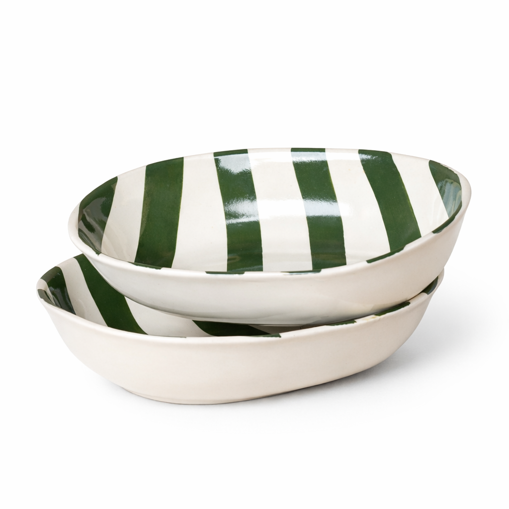 Two ceramic bowls with green and white striped pattern on a white background