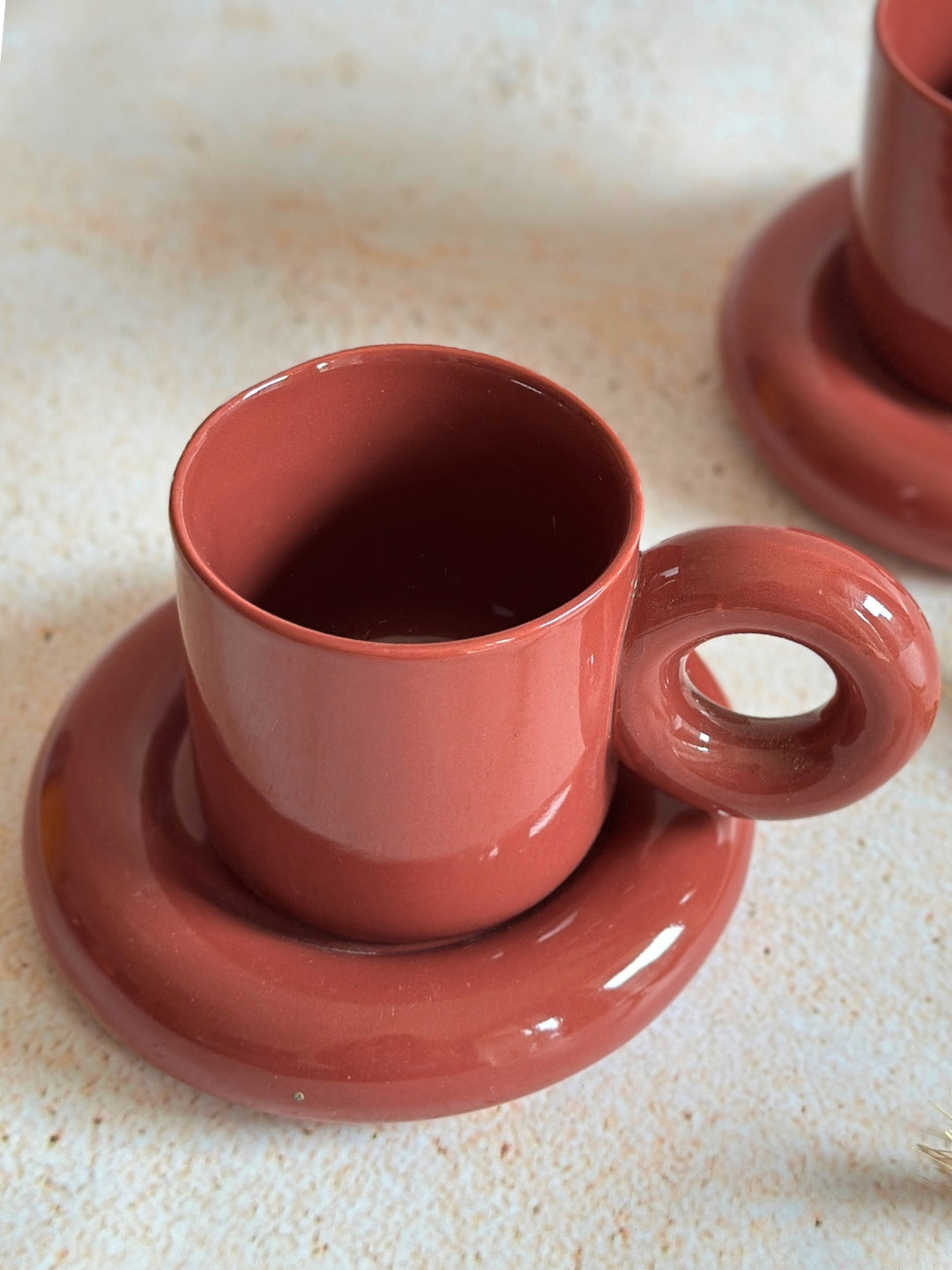 a couple of cups and saucers sitting on a table