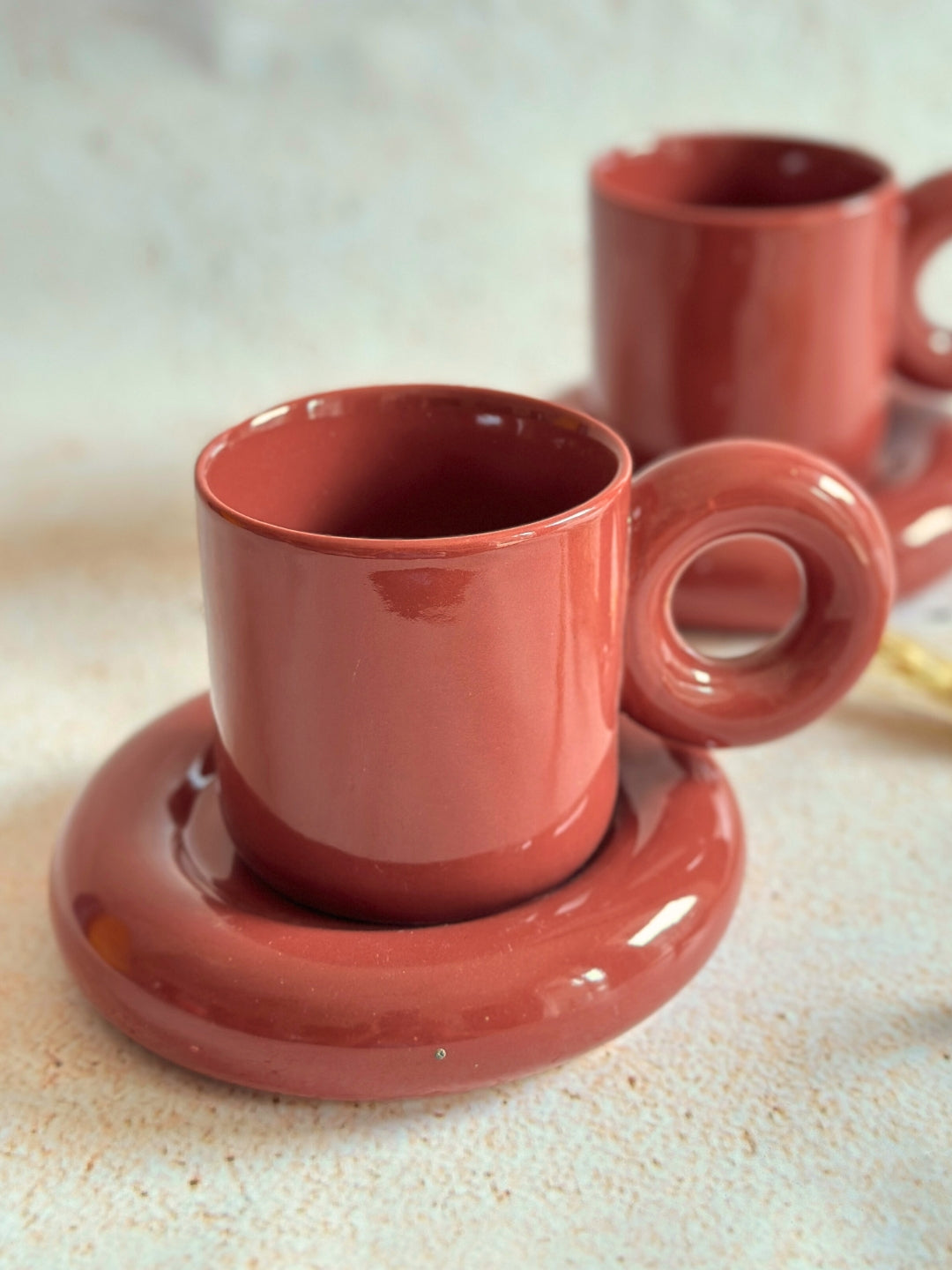 a couple of cups and saucers sitting on a table