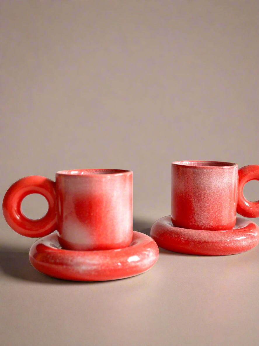 a couple of red cups sitting on top of each other