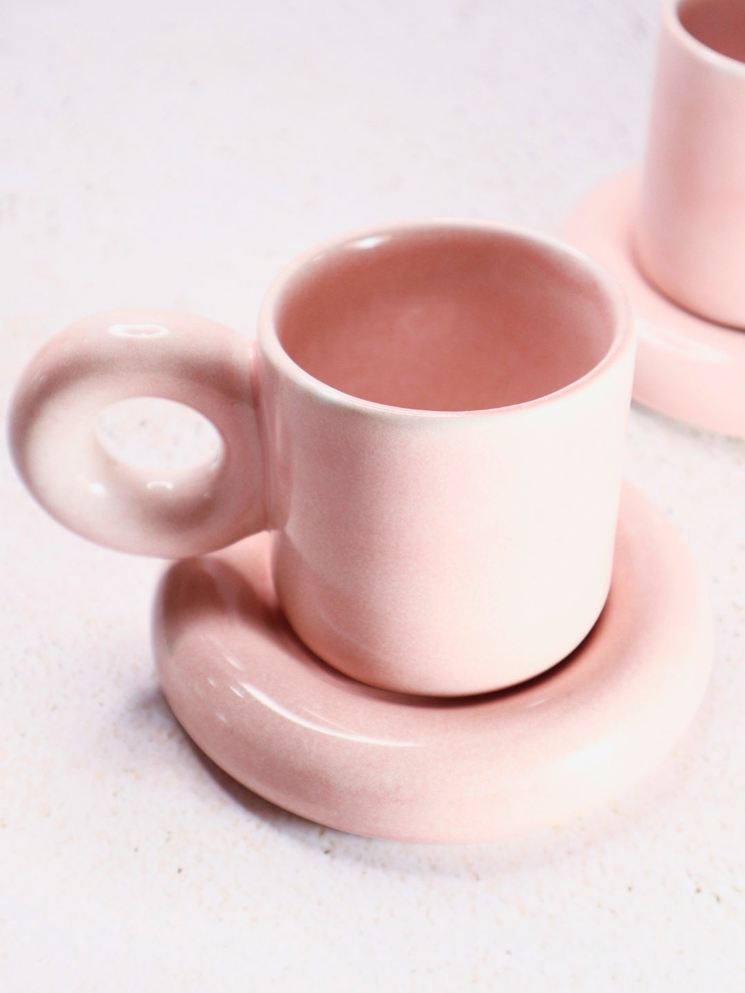 a couple of cups and saucers sitting on a table