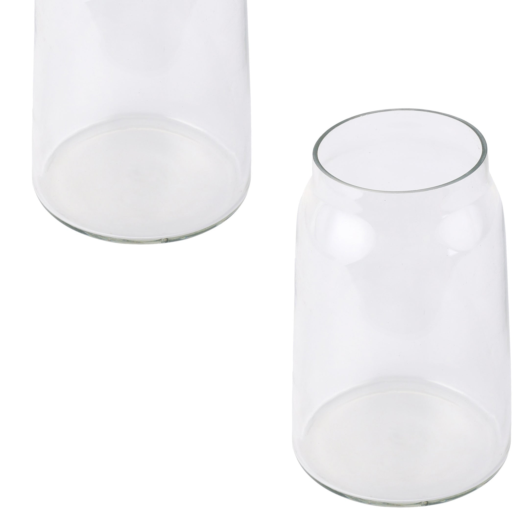 two clear glass vases sitting next to each other