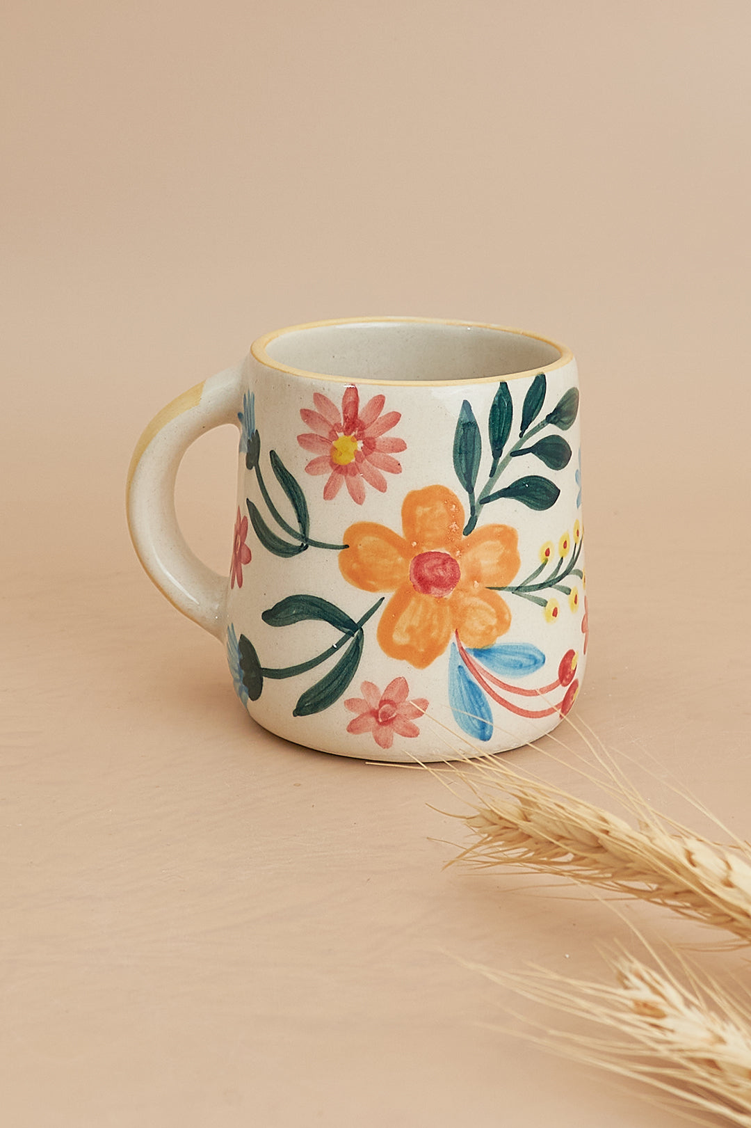 a coffee cup with a flower painted on it